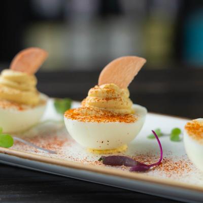 Deviled eggs topped with pickled veggies.