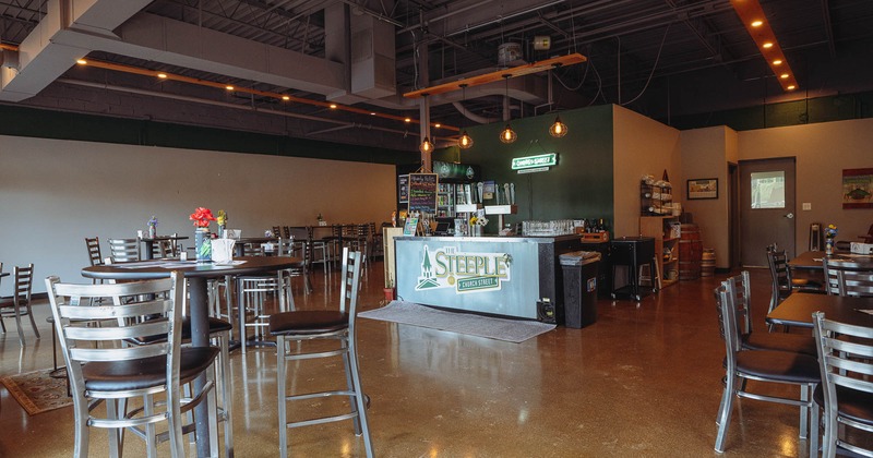 Interior, spacious seating area with bar behind