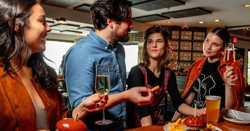 Interior, dining tables ready for guests, two guests chatting