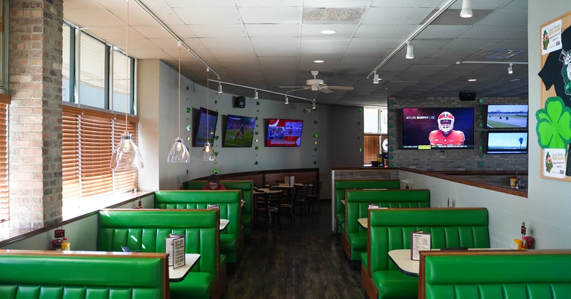 Interior, seating space, booths and big Tv's on the wall