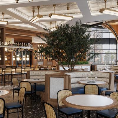 Dining area with curved booths, large indoor olive tree and view of the bar.