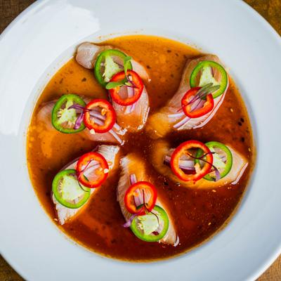 Hamachi crudo appetizer with tuna, ponzu sauce, and jalapeño.