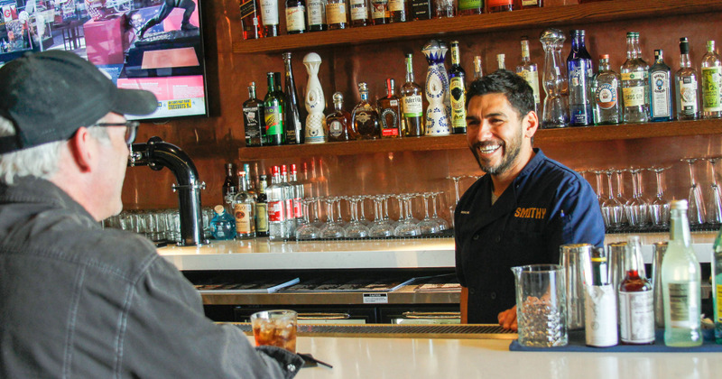 Bar area, staff member talking to a guests