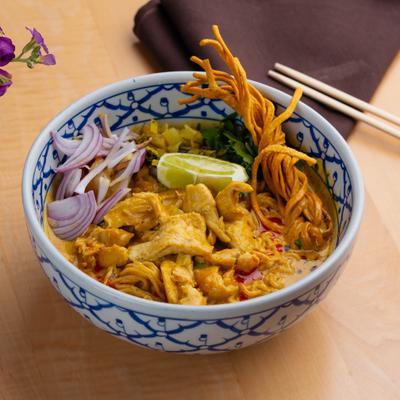Khao Soi curry with chicken, pickled cabbage, onions, scallions and crispy noodles.