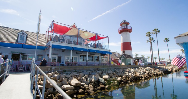 Waterfront view of boat dock, lighthouse, and Dominic's Italian restaurant