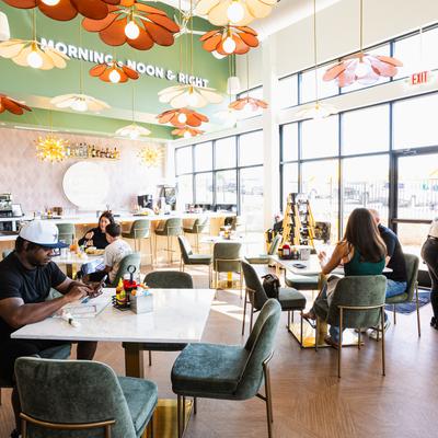 Patrons dine inside the bright restaurant.