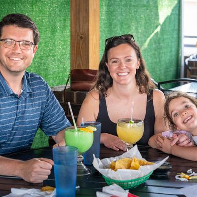 Family enjoying drinks and food at a restaurant.