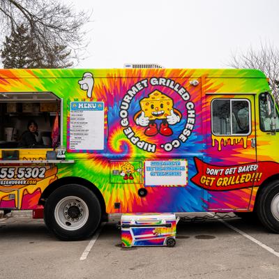 Food truck, side with pickup window and pasted ads.