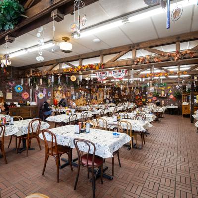 A large dining hall, tables and chairs.