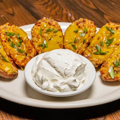 Loaded potato skins served with sour cream.