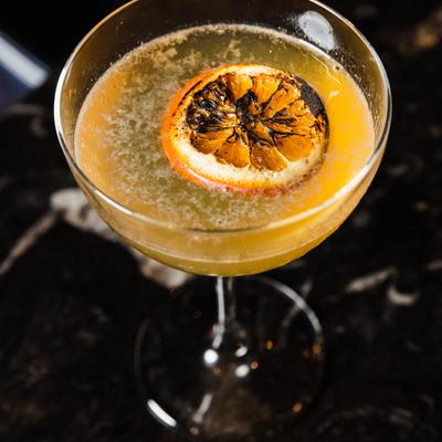 Citrus cocktail with charred orange slice