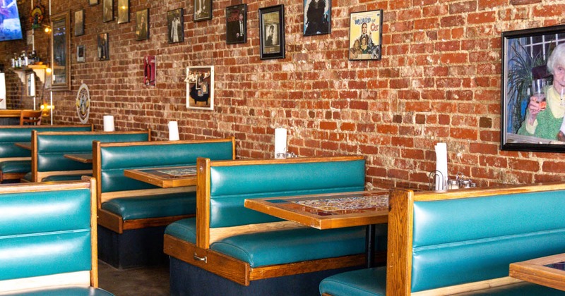 Interior, tables and benches with blue leather cushion and back lined up