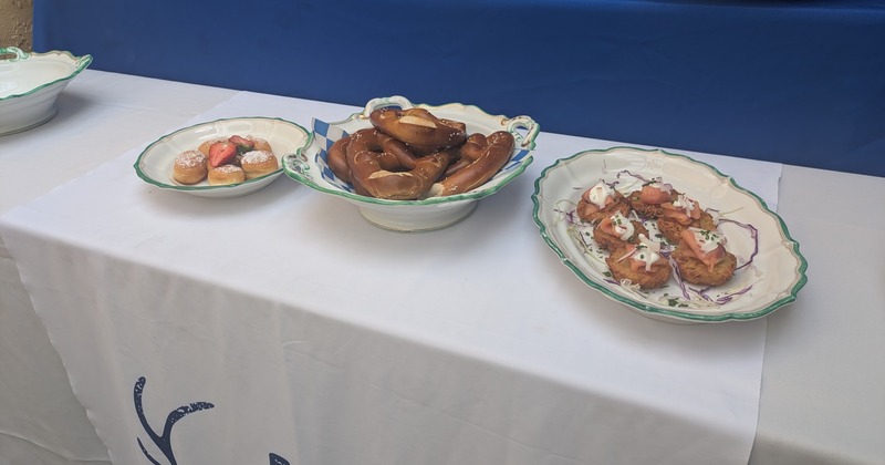 Mini Berliners, Pretzels, and Salmon Potato Pancakes on fancy serving plates