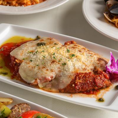Chicken Parmigiana topped with marinara sauce and melted cheese.