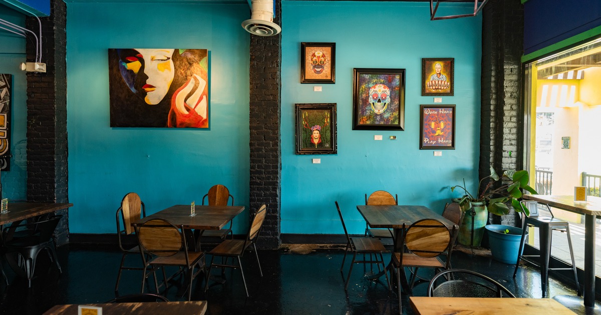 Diner area, tables and chairs decorated wall behind