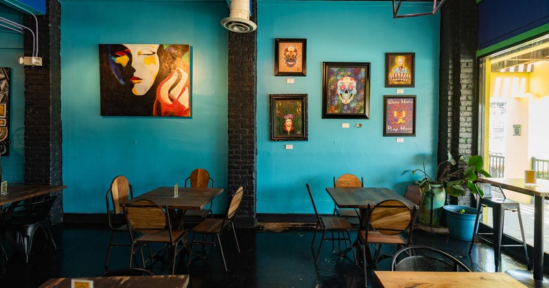 Diner area, tables and chairs decorated wall behind