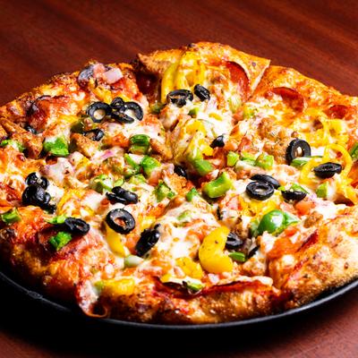 Pizza with cheese, pepperoni, black olives, red onion, tomato, and peppers.