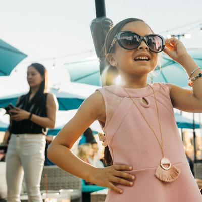 Little girl with glasses smiling in the venue.