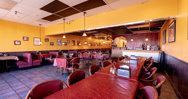 Dining area, table in line, checkout counter and booths by the wall
