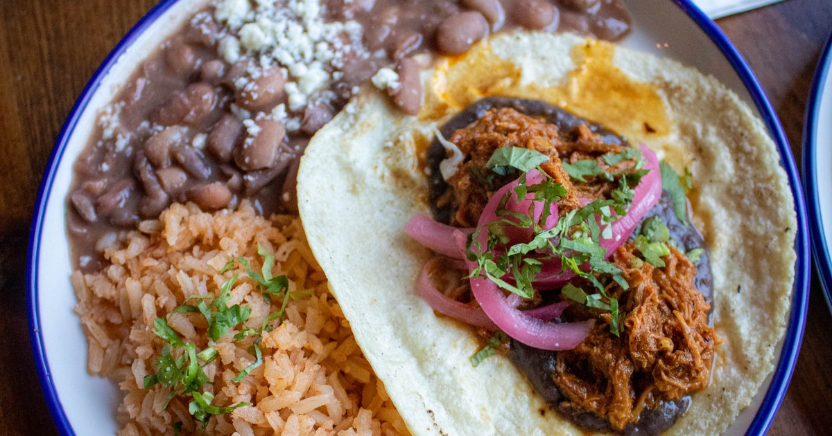 Single taco with sides of rice and beans