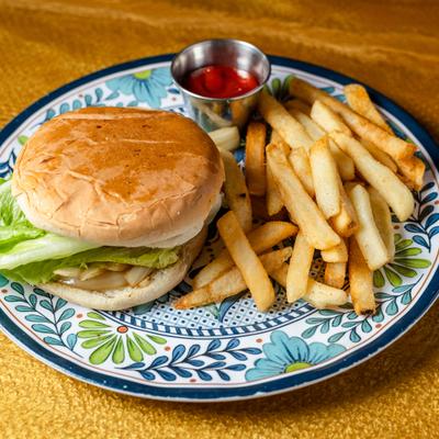 Vegetarian Burger served with a side of fries and a dipping sauce.