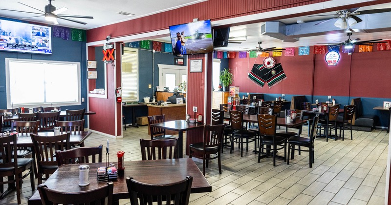 Restaurant interior with tables, chairs and wall decorations