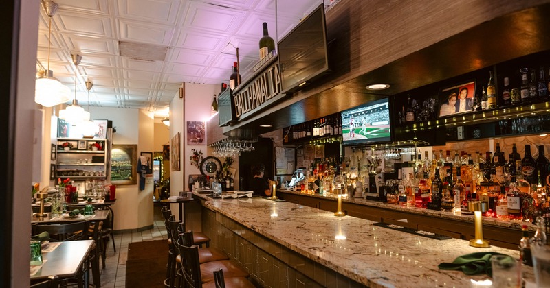 Interior, bar and dining area, marble top bar with stools, tables for four, ready for guests