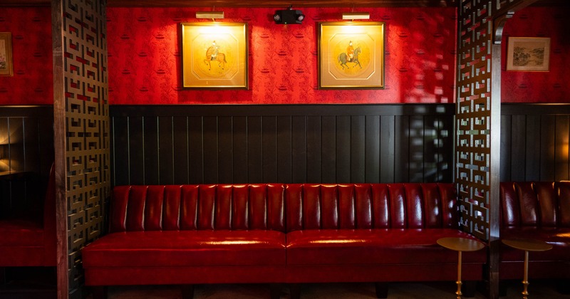 Interior, red leather couch with ornate wall and ceiling decorations