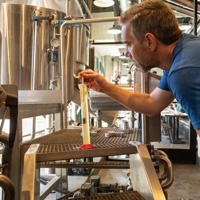 Employee testing the quality of beer.