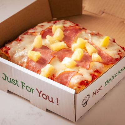 Hawaiian pizza slice in a box.