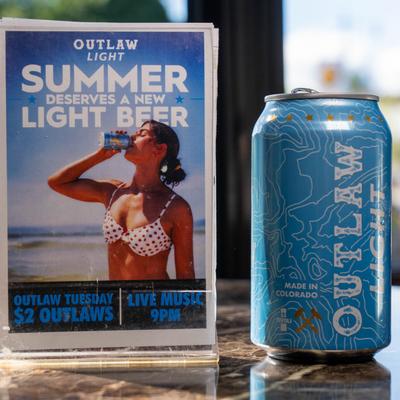 Outlaw light beer can with flyer in the back.