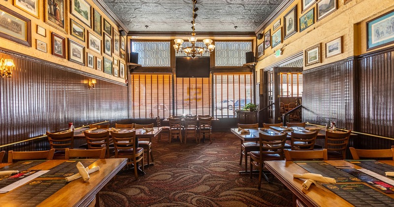 Interior with wooden tables, wall art, and a chandelier