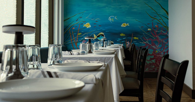 Interior, dining tables and chairs ready for guests