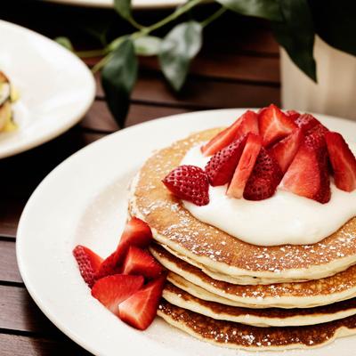 Pancakes, with strawberries and cream.