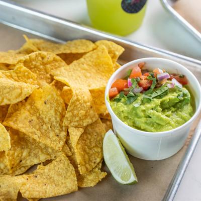 Chips and guacamole served with pico de gallo and lime.
