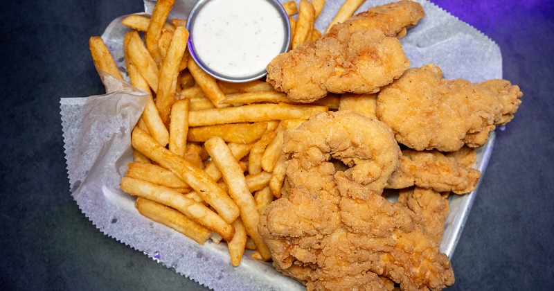 Chicken tenders served with fries and sauce