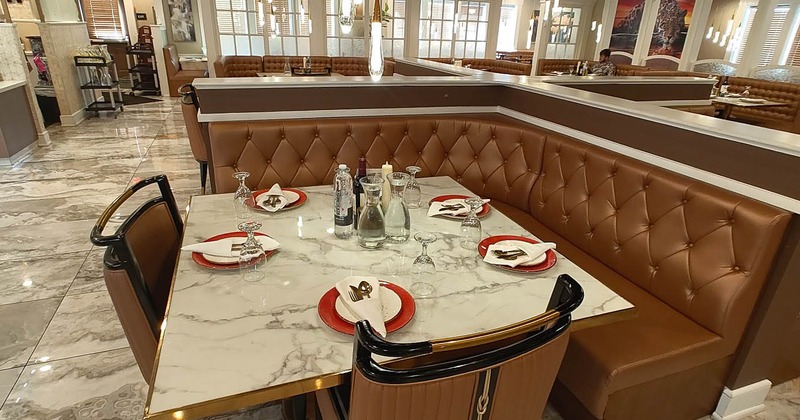 Modern restaurant interior with a marble dining table set for five