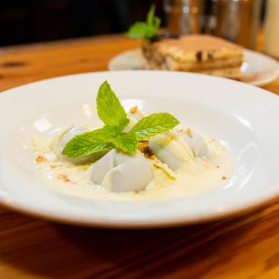 White chocolate ravioli, garnished with mint.