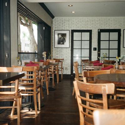 Restaurant dining room with wooden chairs and tables.