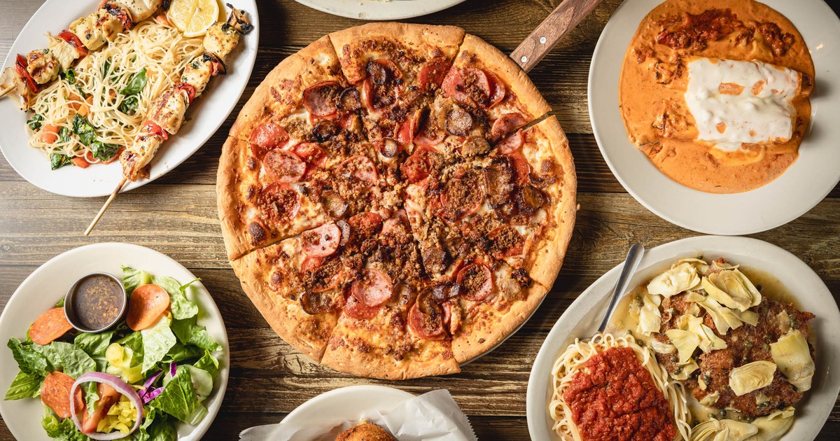 Meat lovers pizza surrounded by various dishes