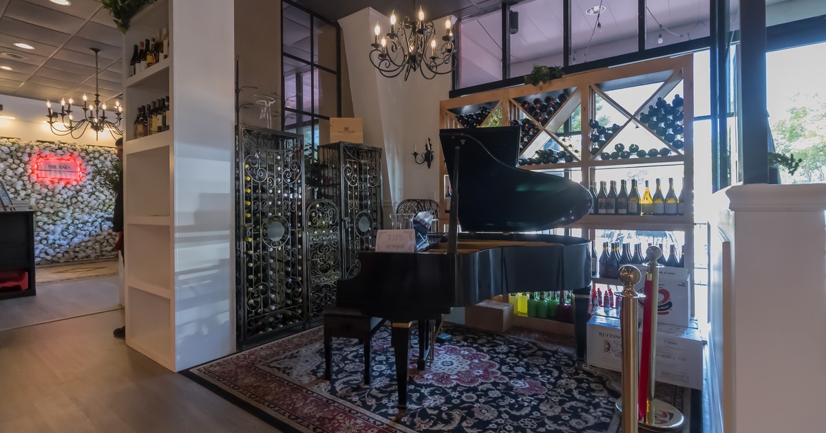 Piano displayed by the wine rack