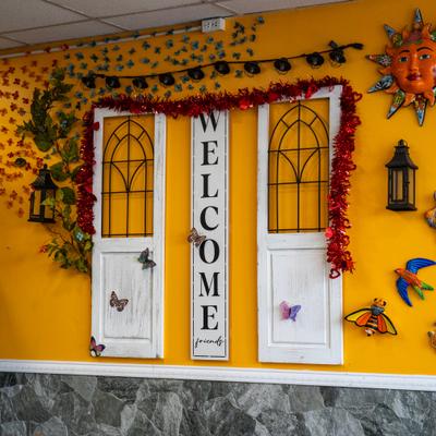 Decorative welcome display with doors on a yellow wall.