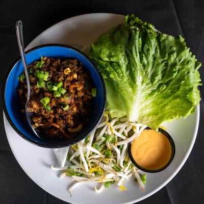 Wild Boar Lettuce Wraps , with bean sprout slaw and sriracha mayo.