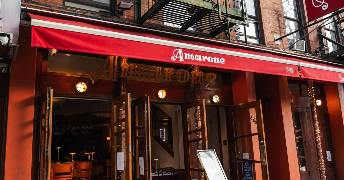 Amarone restaurant storefront with signage and red awning