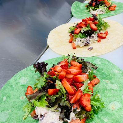 Series of wraps with green and white tortillas being prepared.