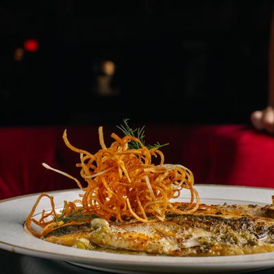 “Fish Calle Dragones” with crispy garnish.