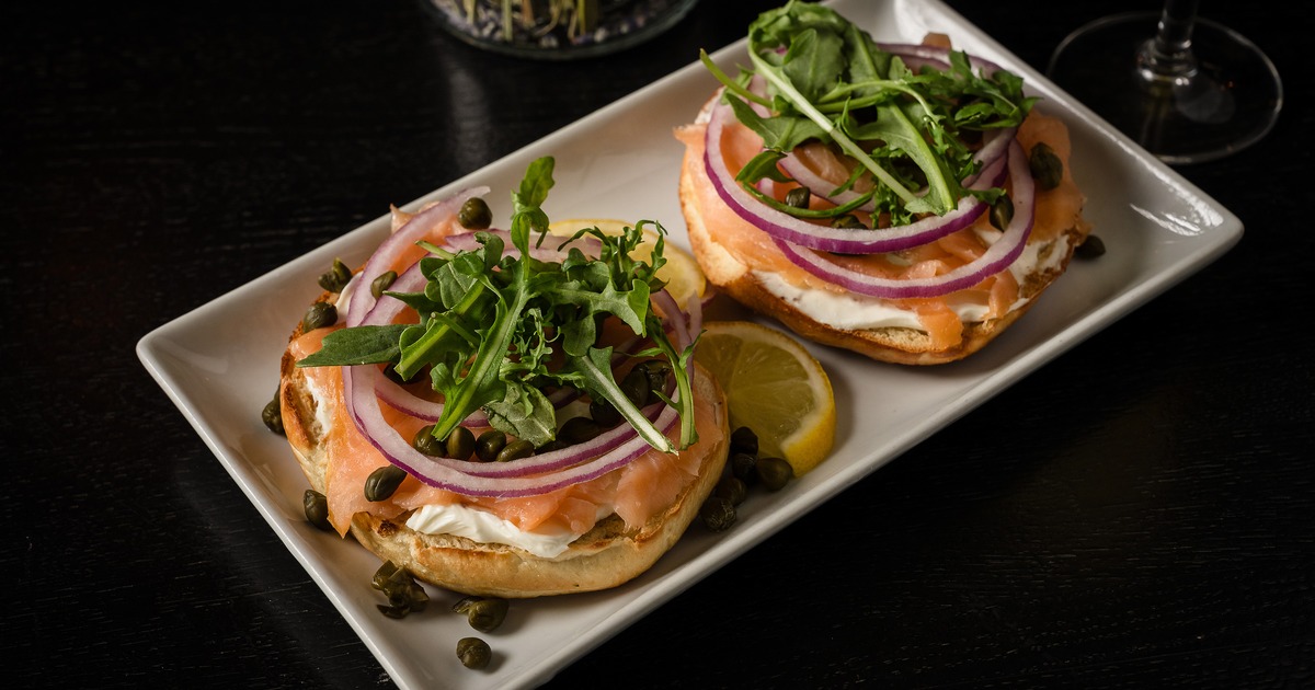 Lox Bagel topped with capers, onion and arugula