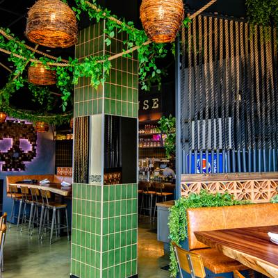 Dining area, hanging lanterns, green pillar with mirrors.