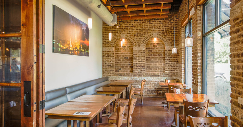 Tables by the wall and by the window, brick wall