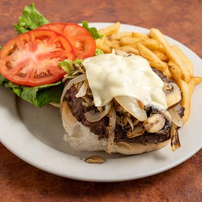 Cheeseburger with grilled onions, mushrooms, lettuce, tomatoes, and fries.